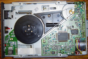 the floppy drive, showing the flywheel and motor drive belt